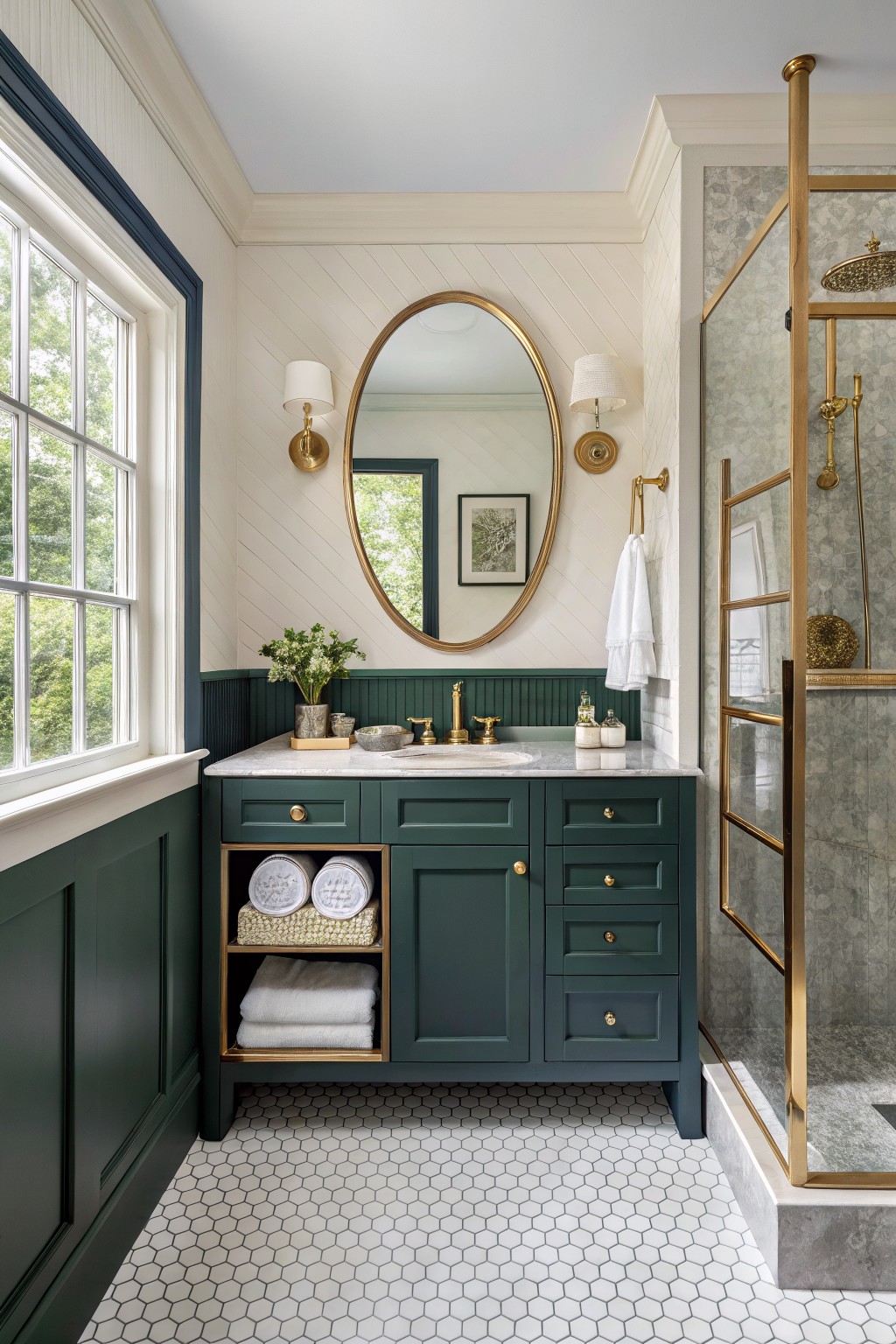 Bathroom vanity with deep green cabinets, white shiplap walls, gold mirror and hardware, glass shower enclosure
