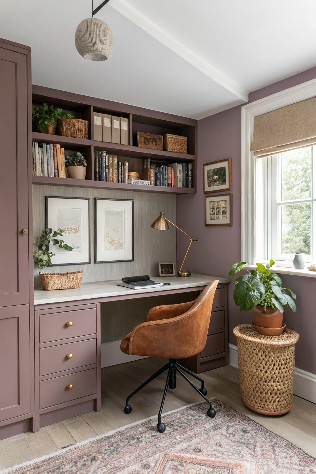 A home office with soft lavender walls and built-in desk shelving.