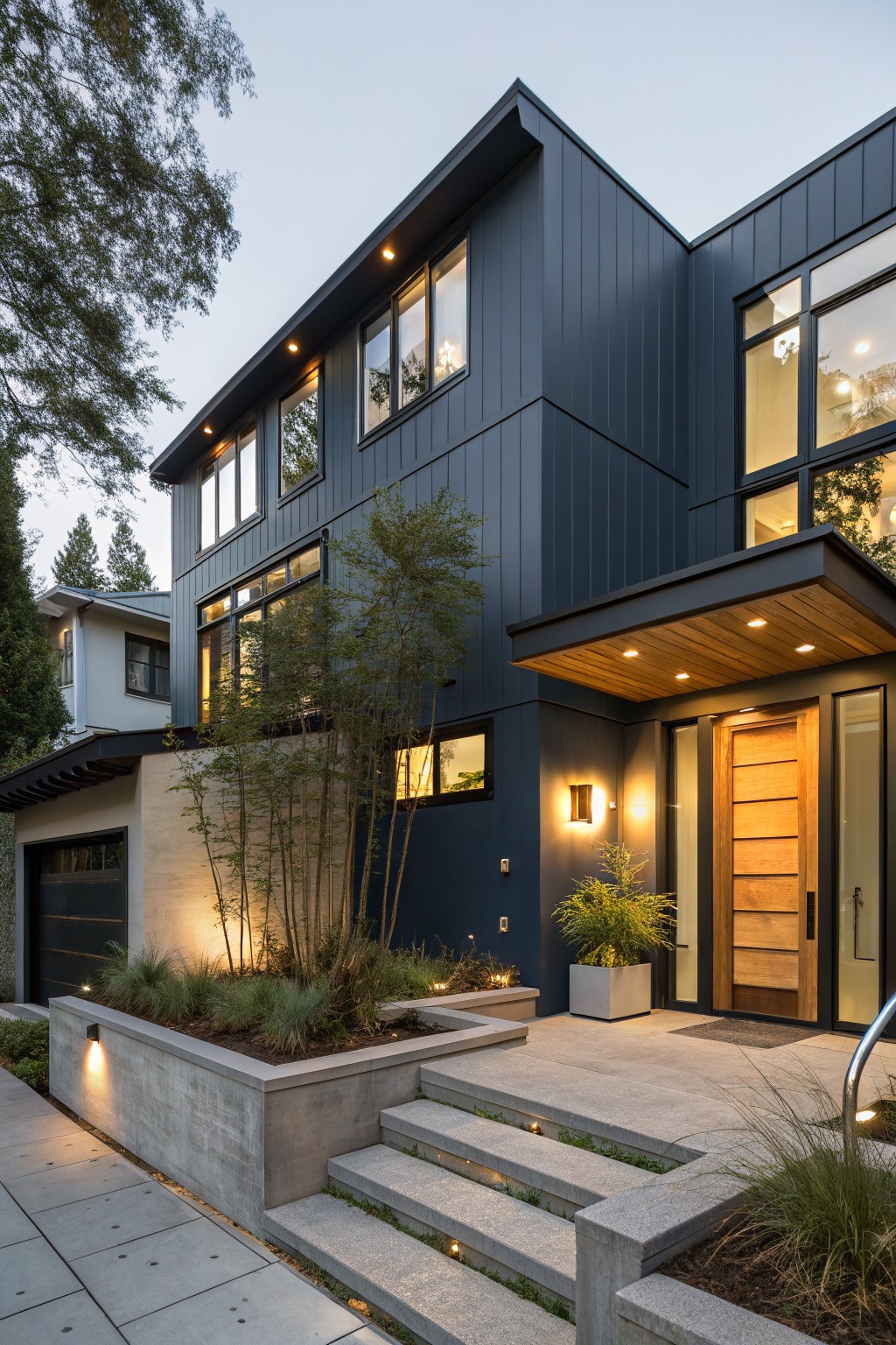Modern house exterior painted in deep blue gray siding with wood accents.