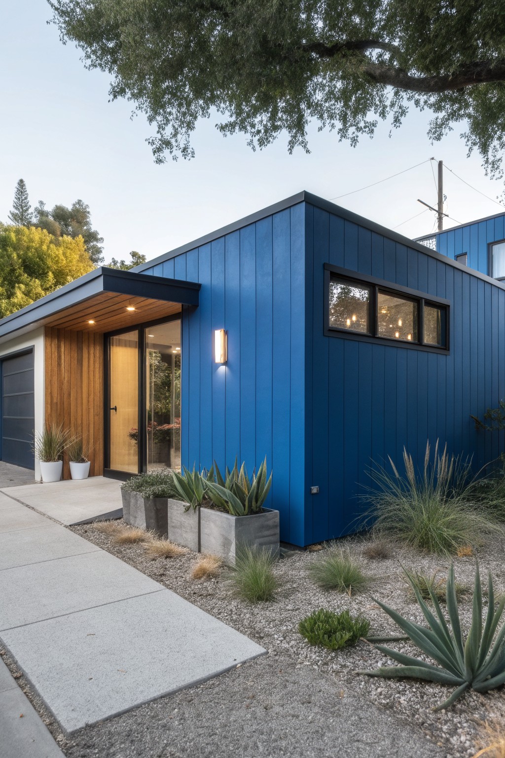 A modern house with bold blue exterior siding and black trim.