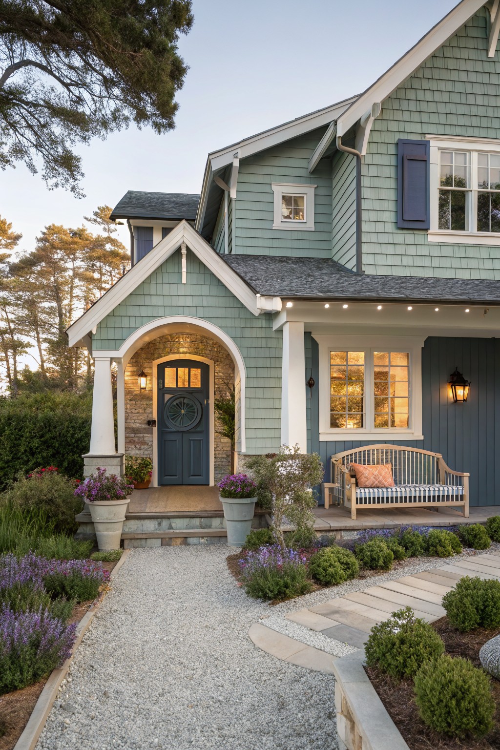 A house exterior painted in soft sage green siding with white trim.
