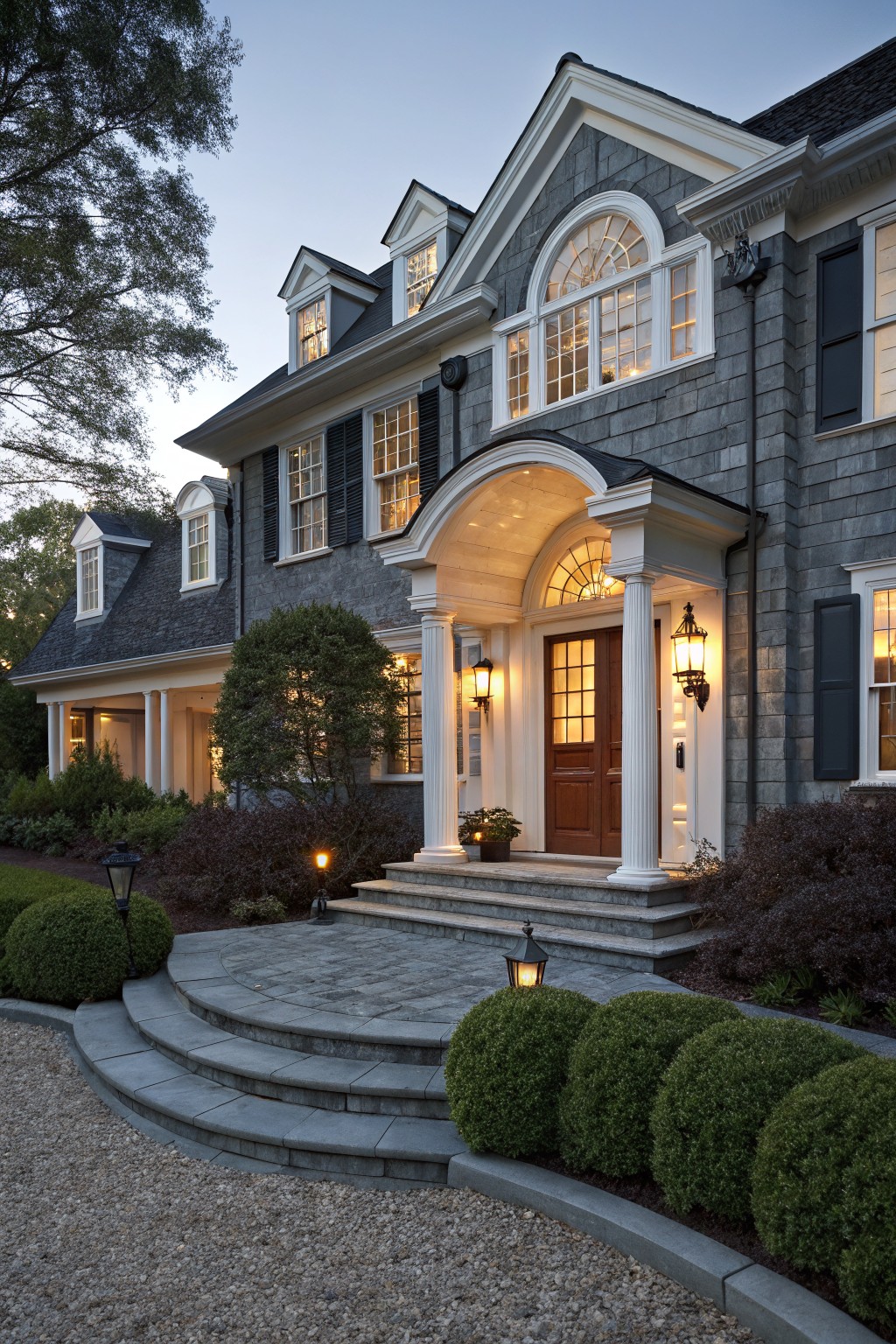 A house exterior featuring dark slate gray siding with white trim around the entry.