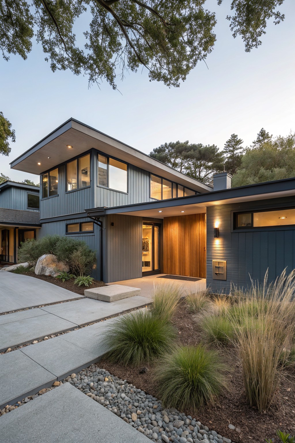 A house exterior with muted blue gray siding and wood accents around the entry.