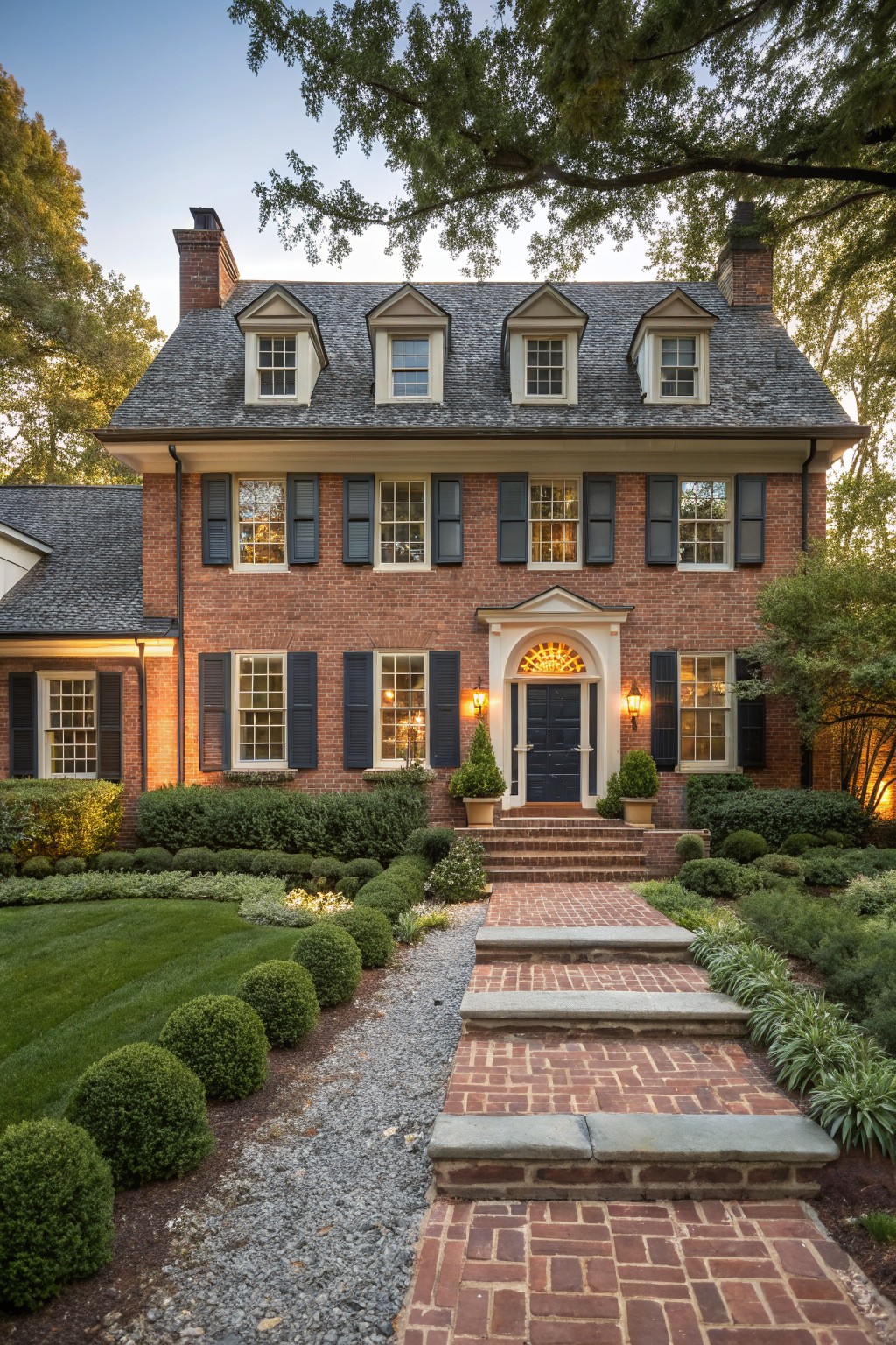 A red brick house with creamy white trim around the windows and door.