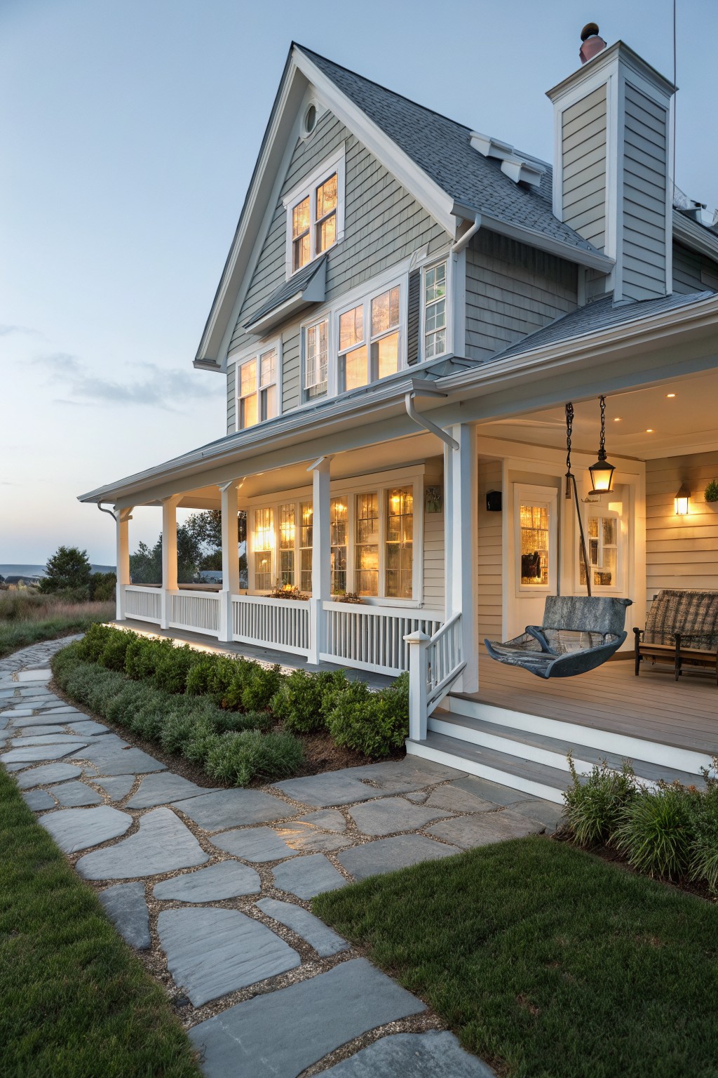 A house with soft blue gray siding and white trim along the porch.
