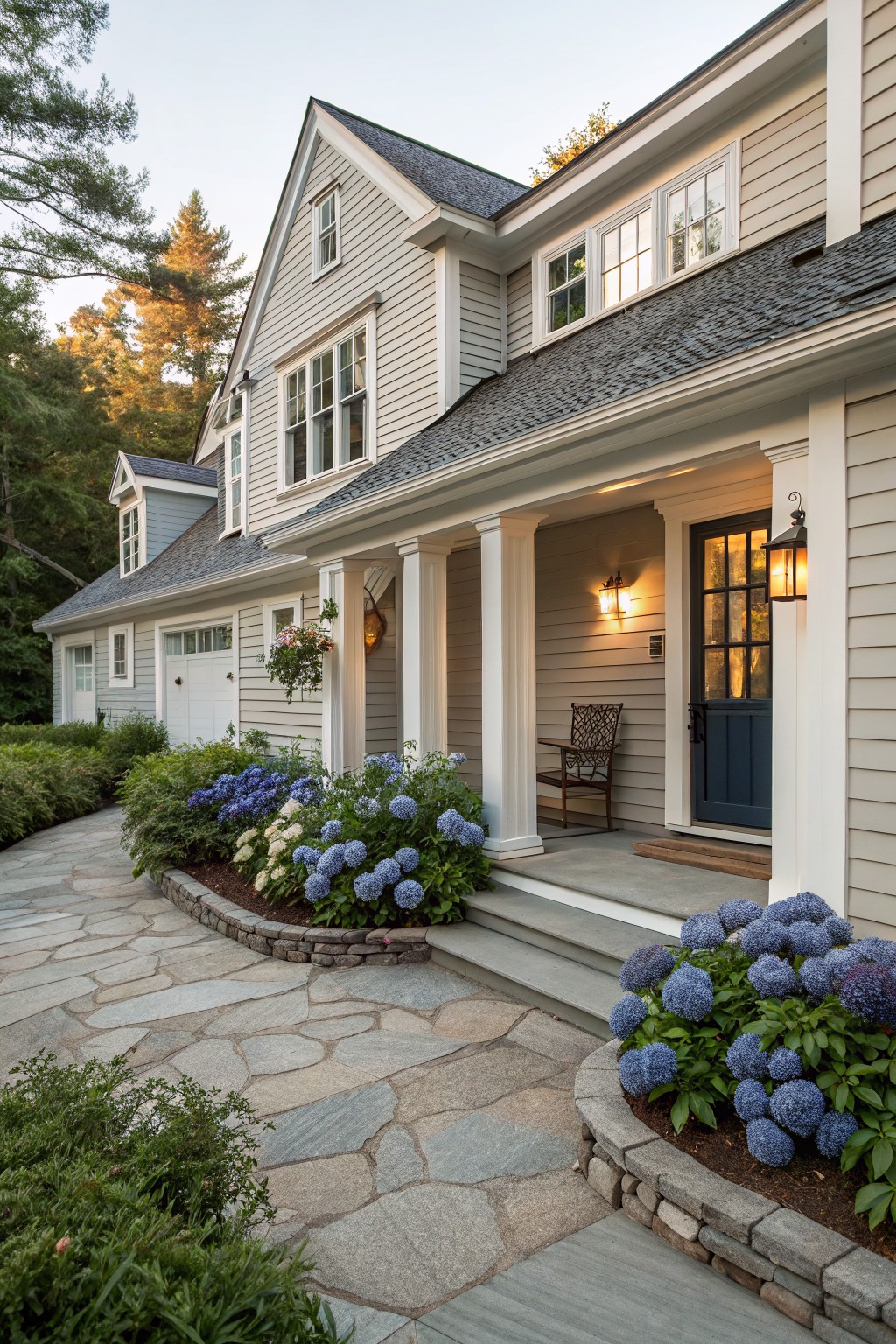 A house exterior painted in soft gray siding with white trim and columns.