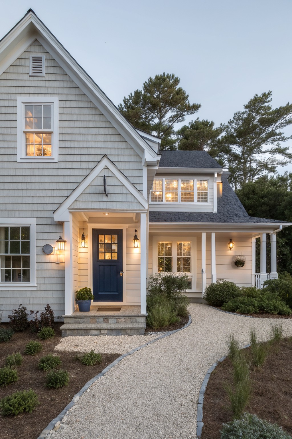 A house with light gray siding, white trim, and a dark front door.
