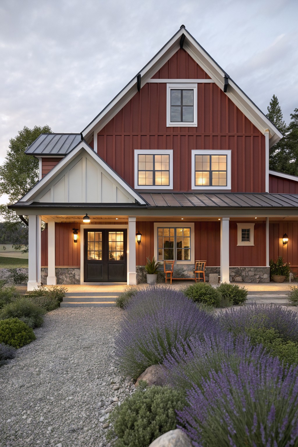 A house exterior painted in deep red with white trim and a stone foundation.