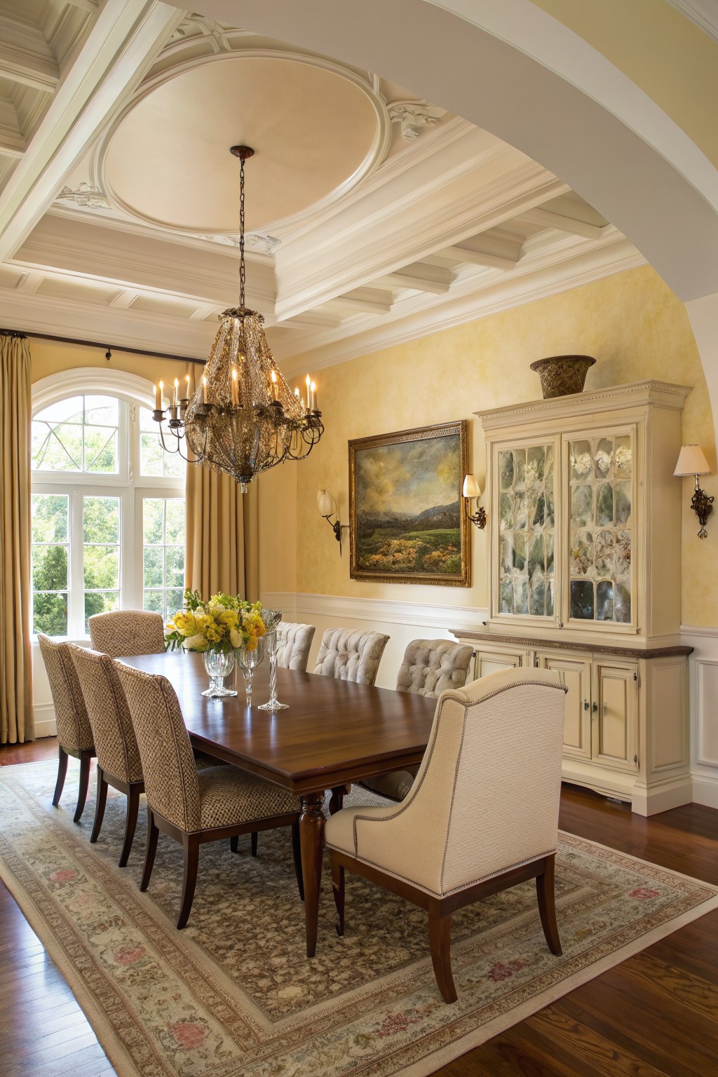Warm golden yellow walls in a classic dining room with a long wooden table and upholstered chairs.