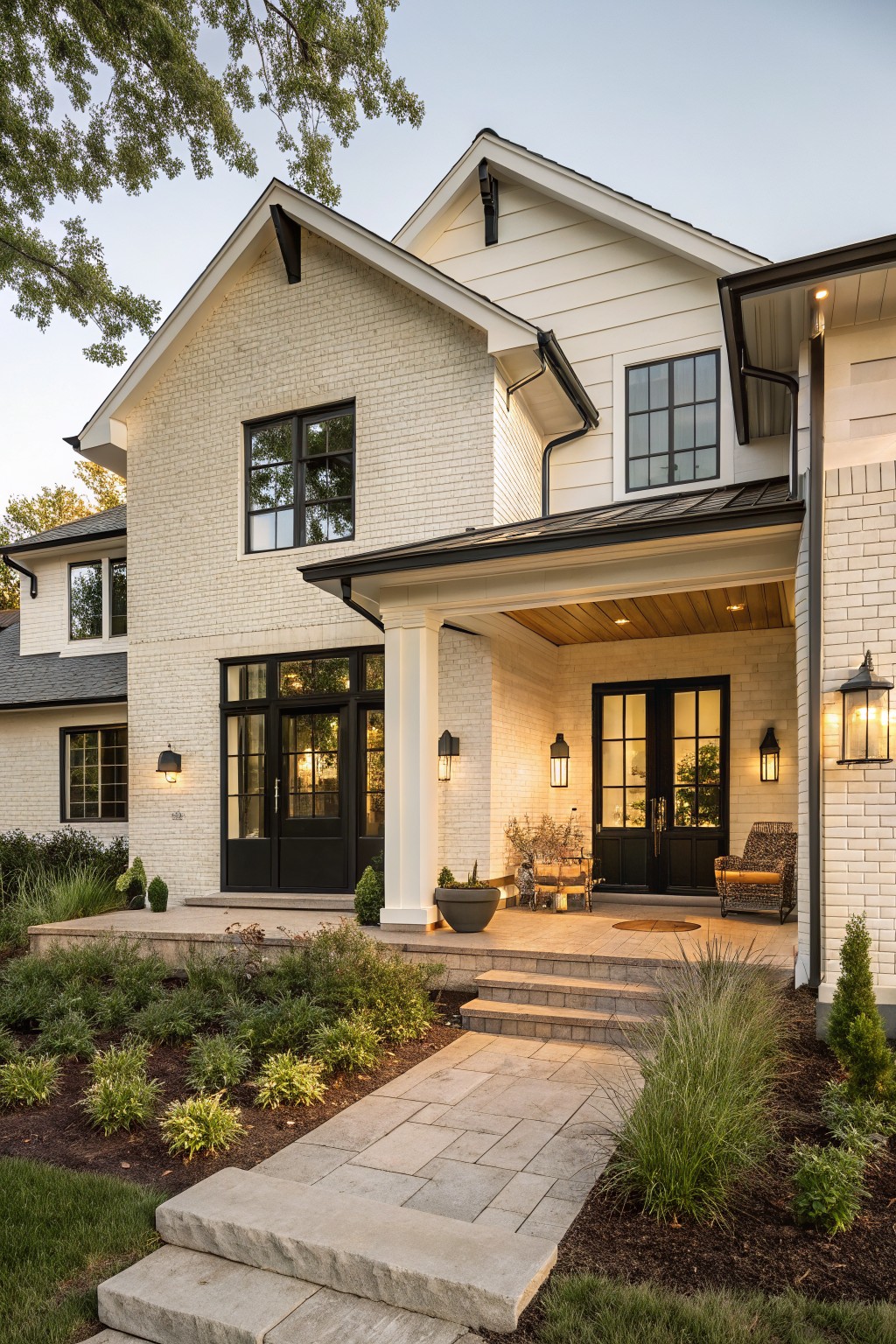 A modern two-story house painted in crisp white brick and siding with black windows.