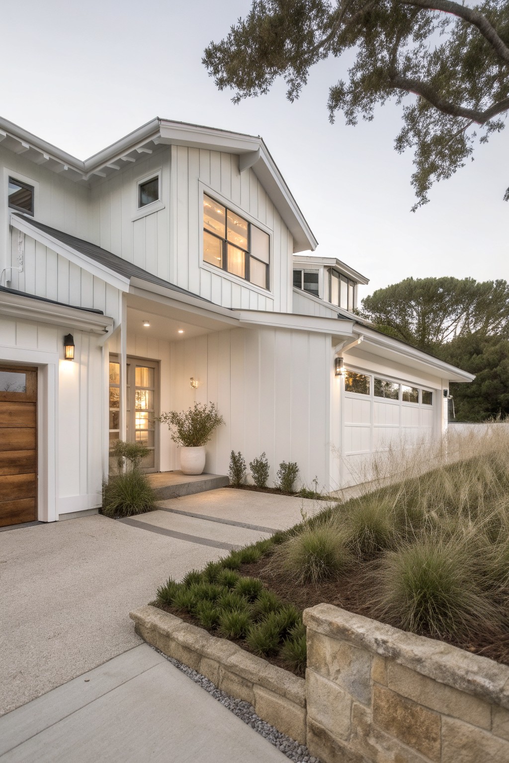 A modern house with crisp white siding and matching garage door.