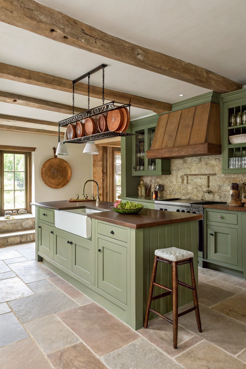 Charming kitchen with green cabinetry, wooden beams, and a central island with decor.
