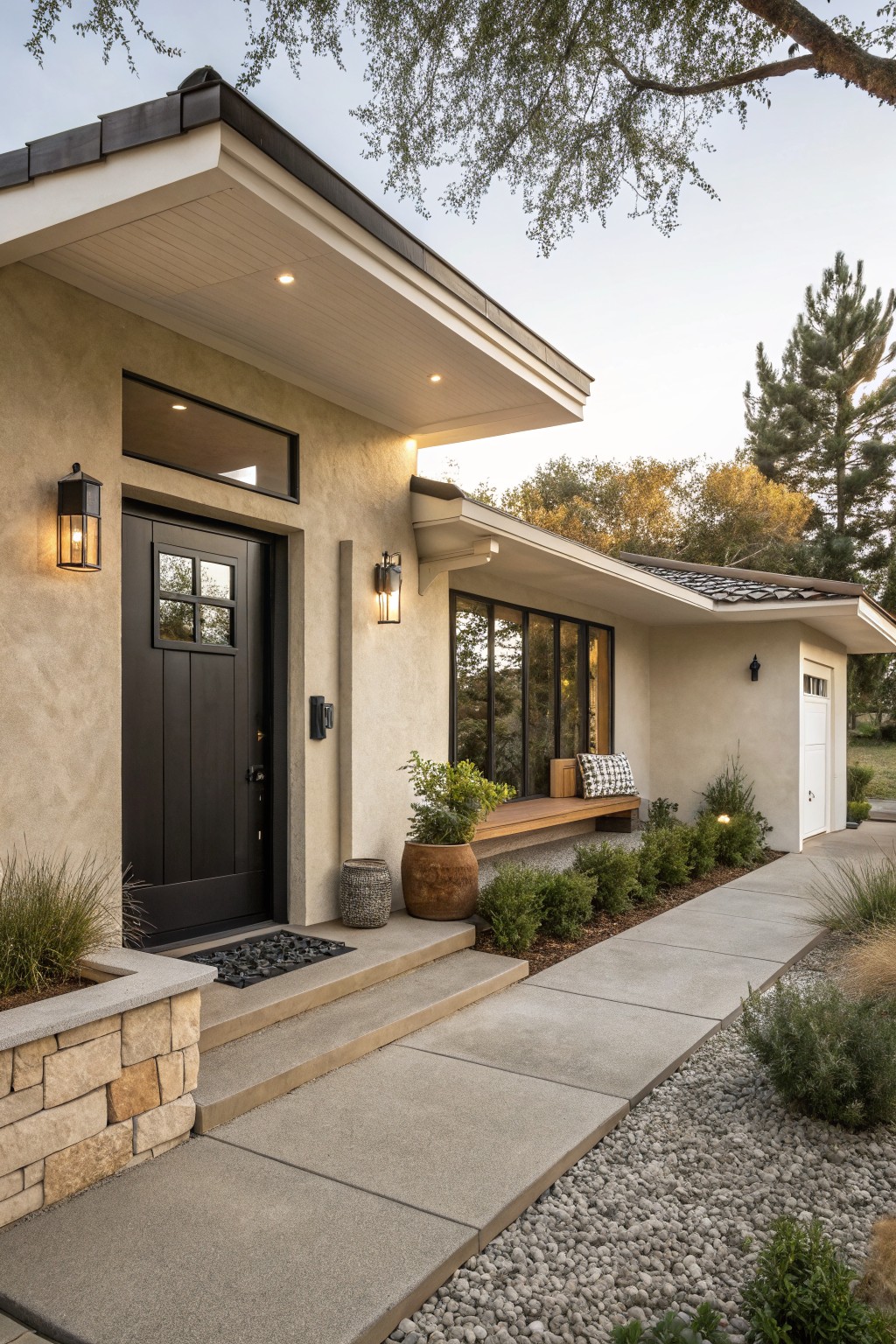 Modern home entrance with black door, stone accents, and landscaped pathway.