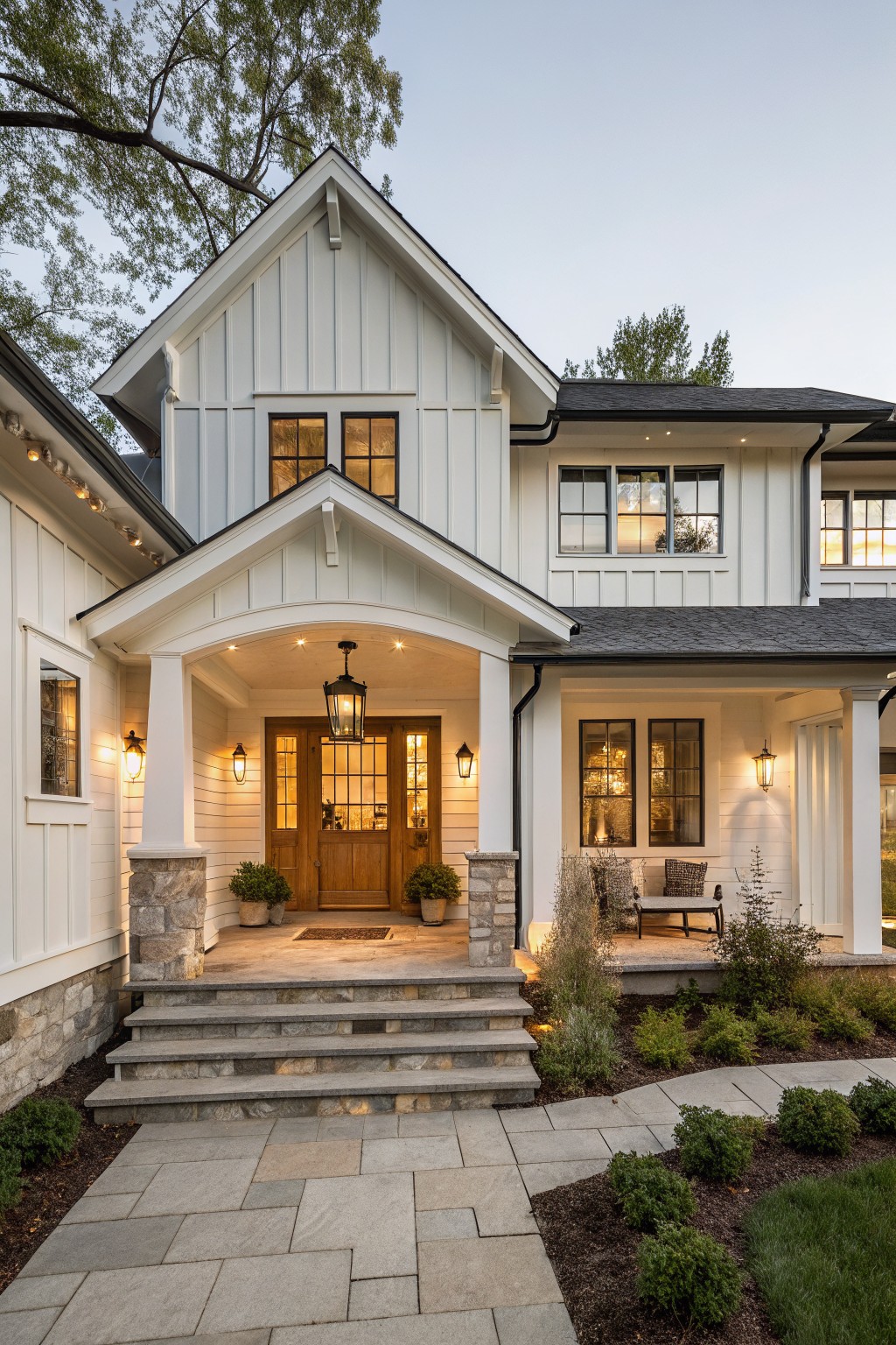 A modern home exterior with soft white painted siding and a front porch.