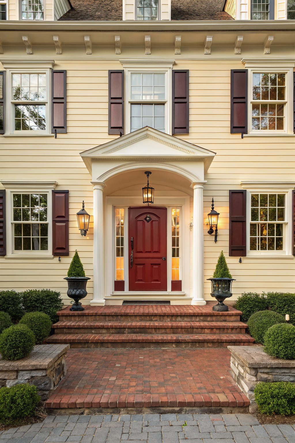 A house exterior painted in soft warm cream siding with white trim.