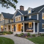 A house exterior with deep navy blue siding and white trim around the porch and windows.