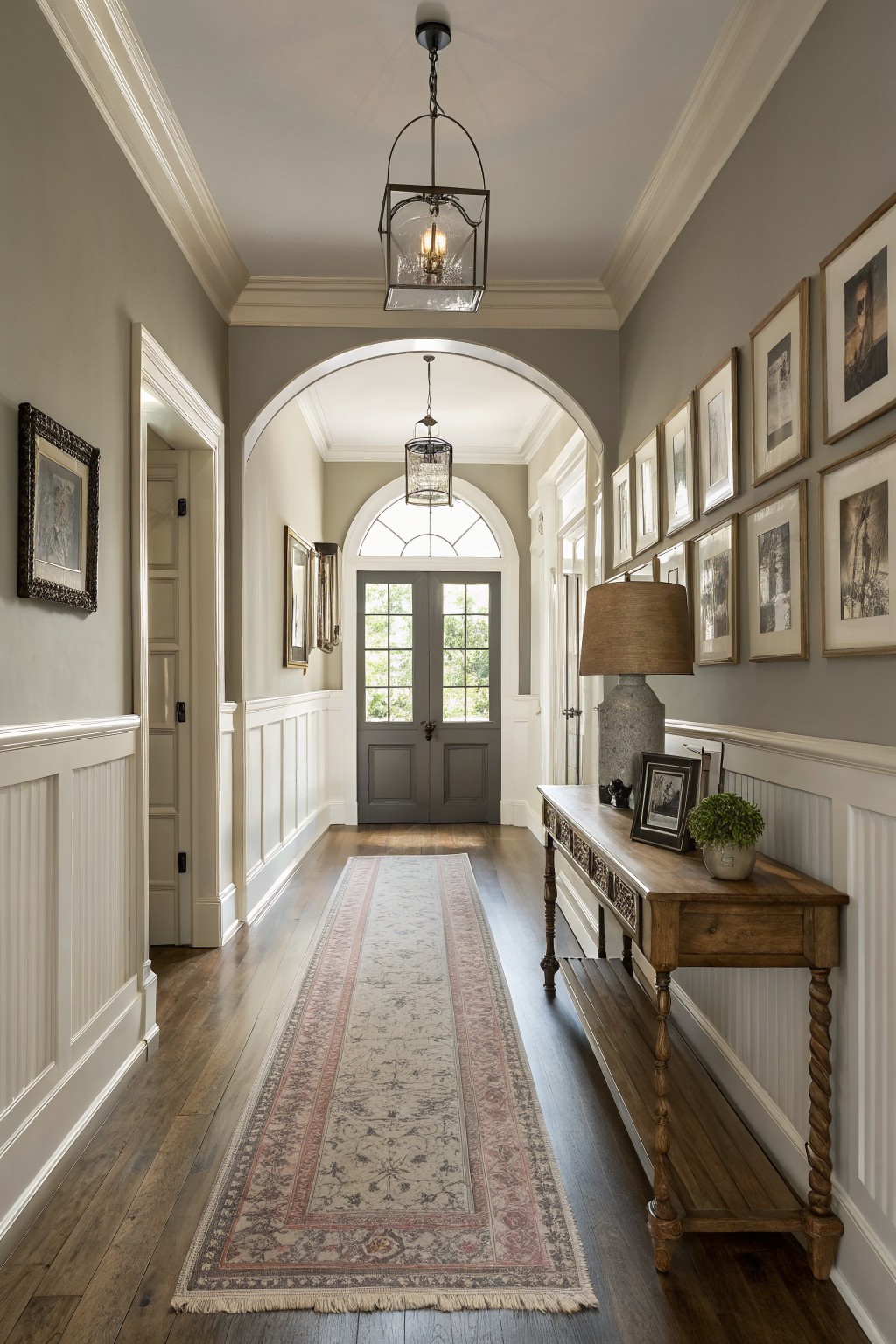 A hallway painted in soft warm gray with white wainscoting and trim.