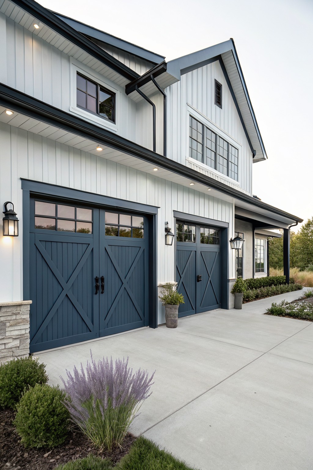 Light siding and deep navy garage doors on a modern house exterior.