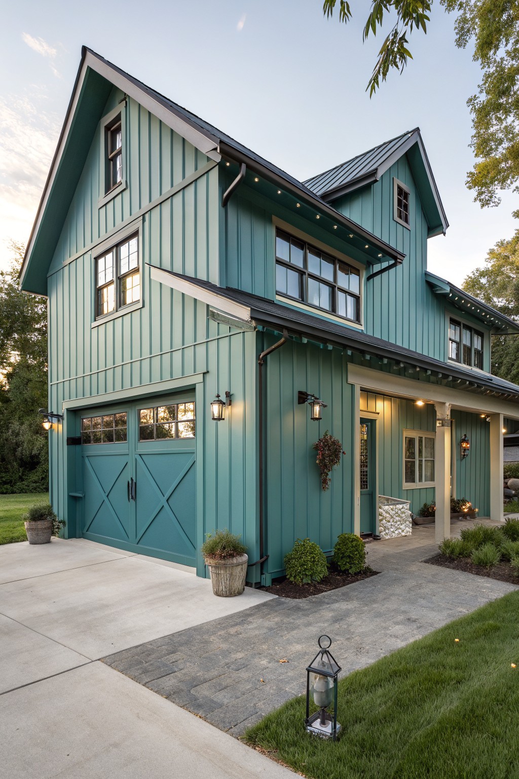 A two-story house with muted teal siding and a dark metal roof.