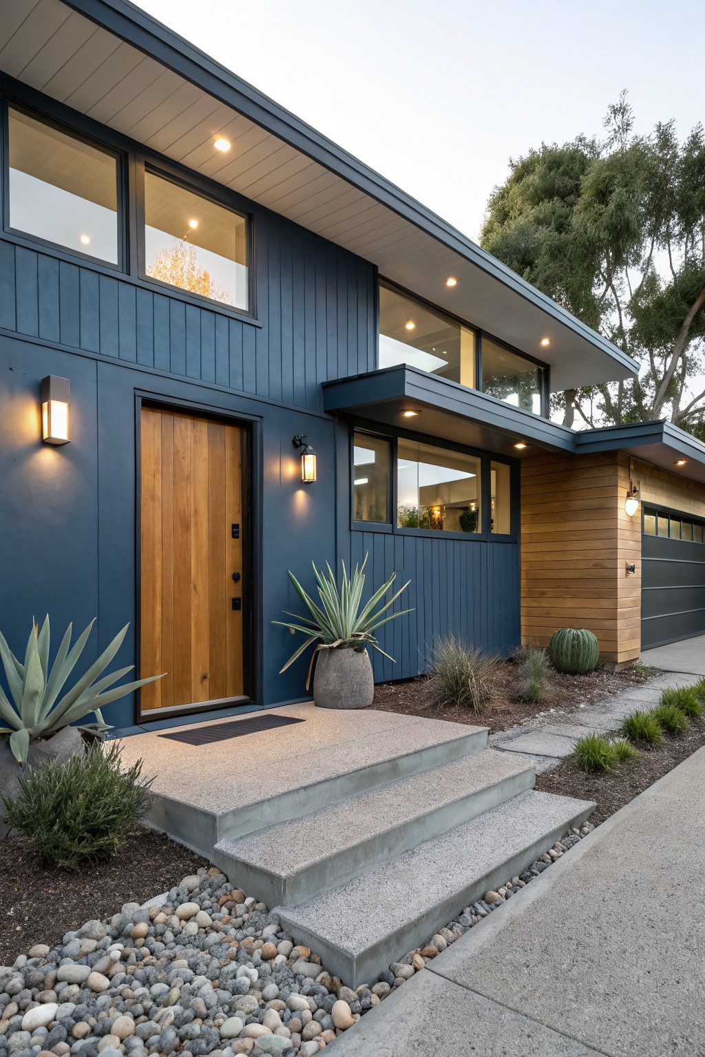 A modern house with dark blue siding and a wooden front door.