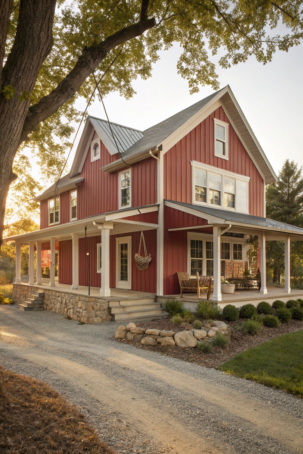 A house exterior painted in a deep red with white trim and a gravel path leading up to the porch.