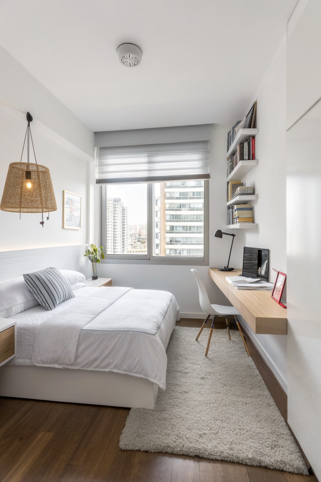 Crisp white walls in a minimal bedroom with wood floors.