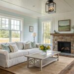 White trim and paneling in a farmhouse living room with wood floors.