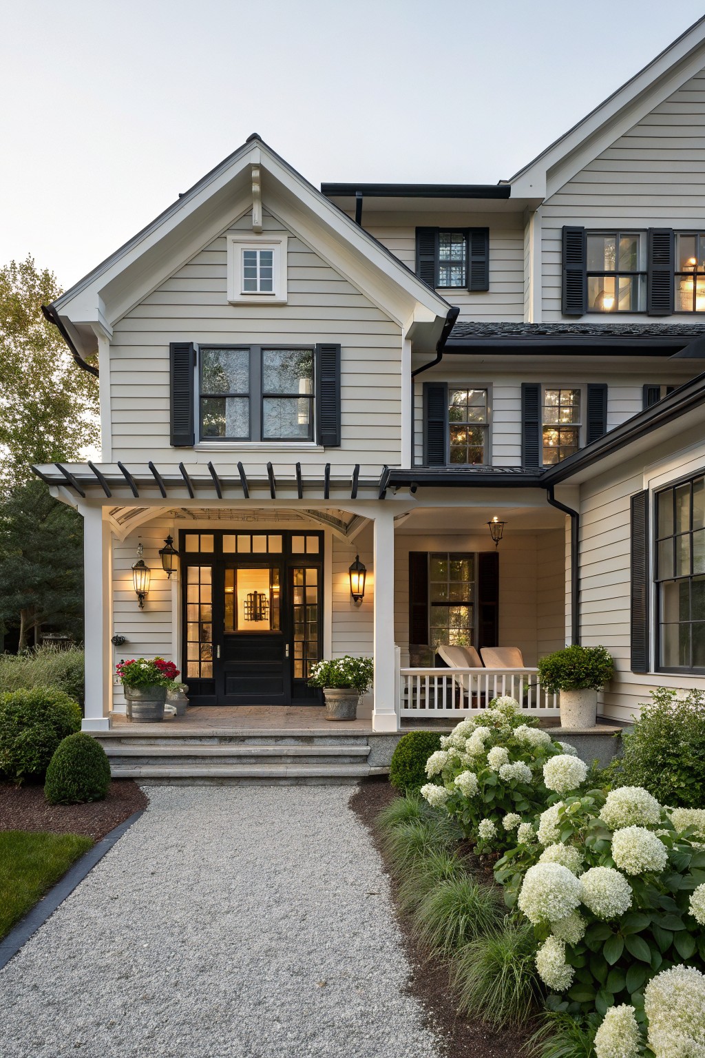 A farmhouse exterior with soft greige siding and white trim.
