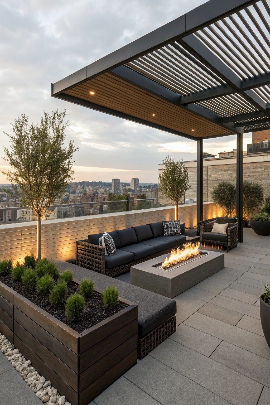 Modern rooftop patio with sectional sofa, fire pit, and city skyline view at dusk