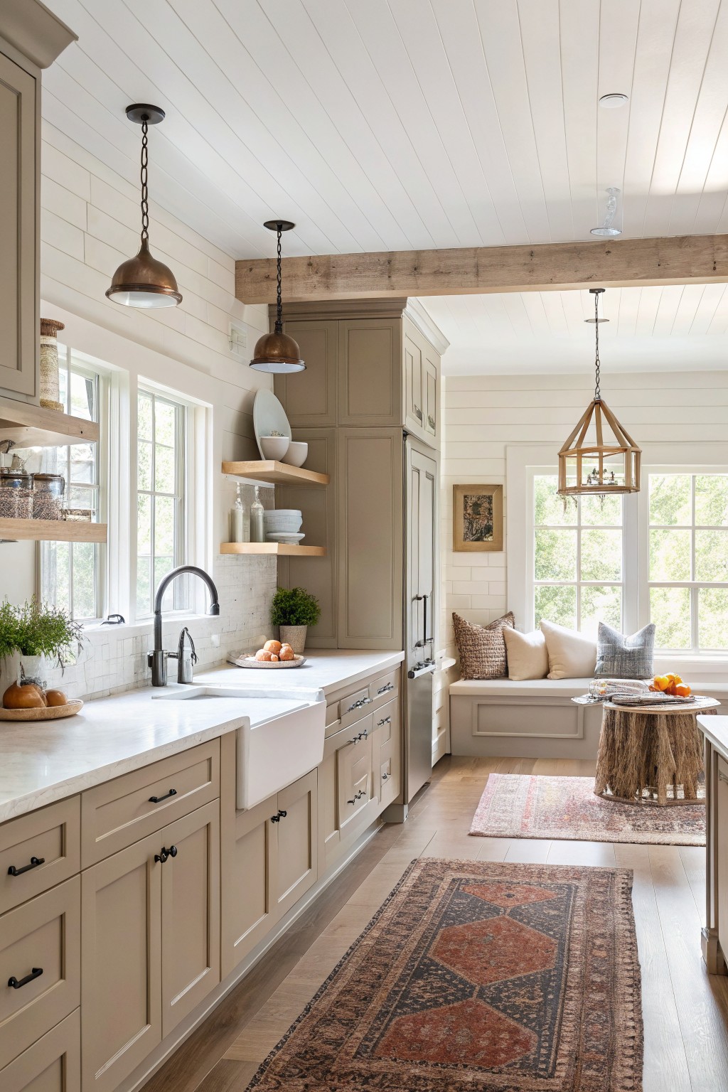 Kitchen with soft greige cabinets and white countertops in a bright farmhouse space.