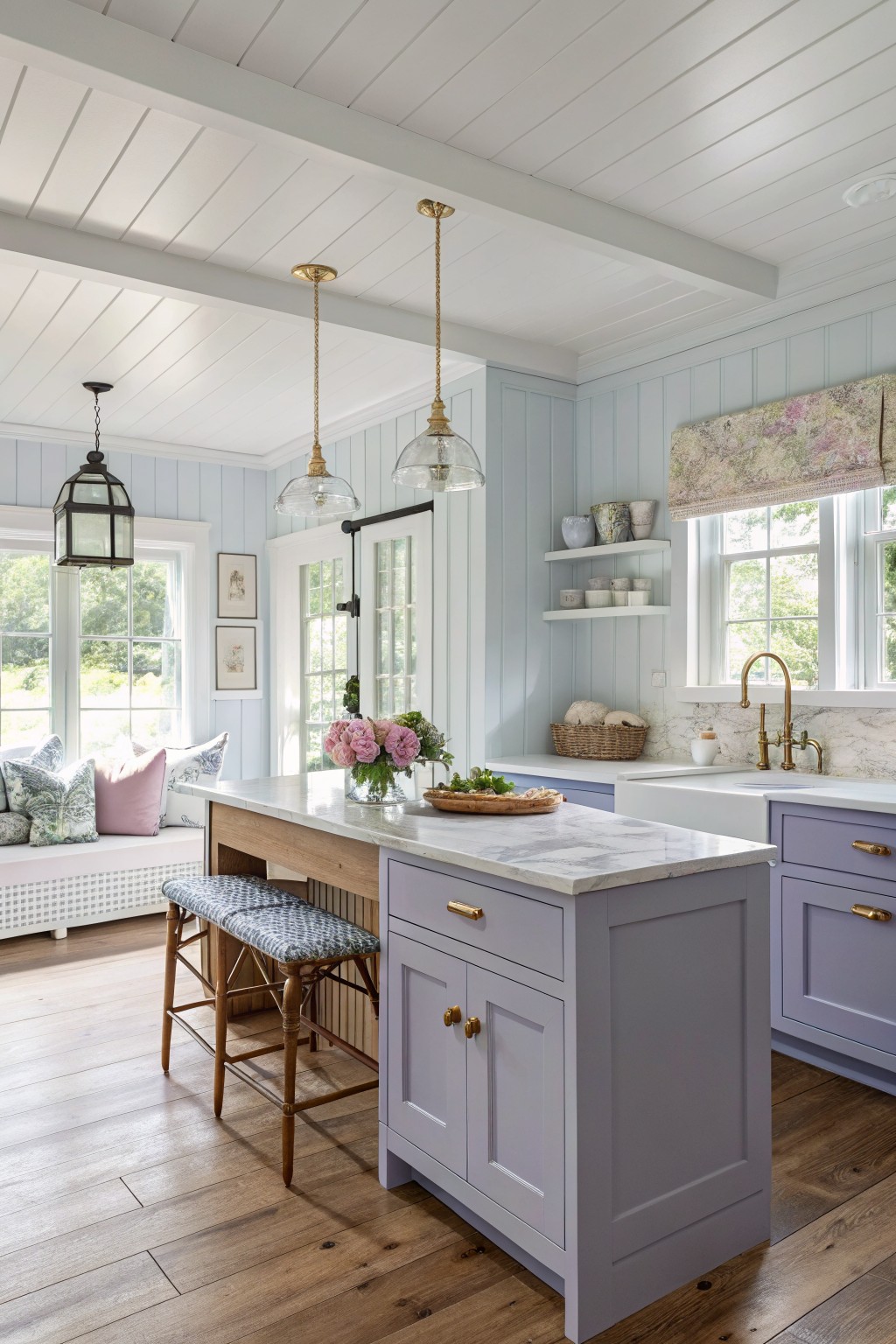 Light lavender gray cabinets in a farmhouse kitchen with white marble counters.