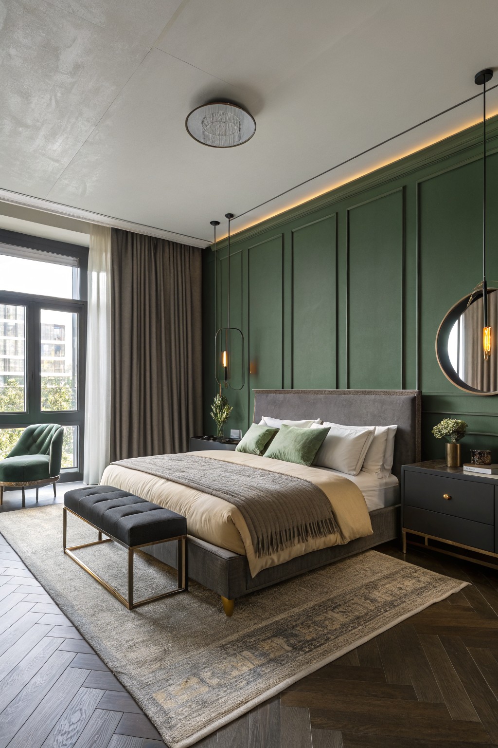 A bedroom featuring deep green paneled walls around a large bed.