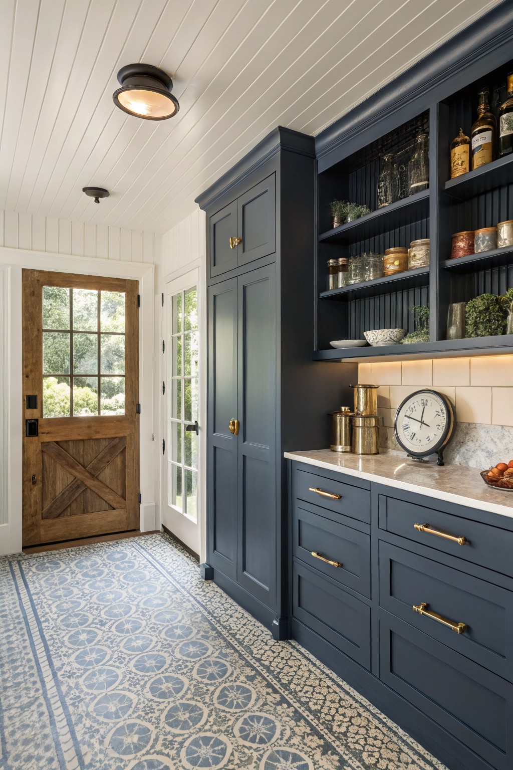 Dark navy blue cabinetry in a bright farmhouse interior with patterned tile flooring.