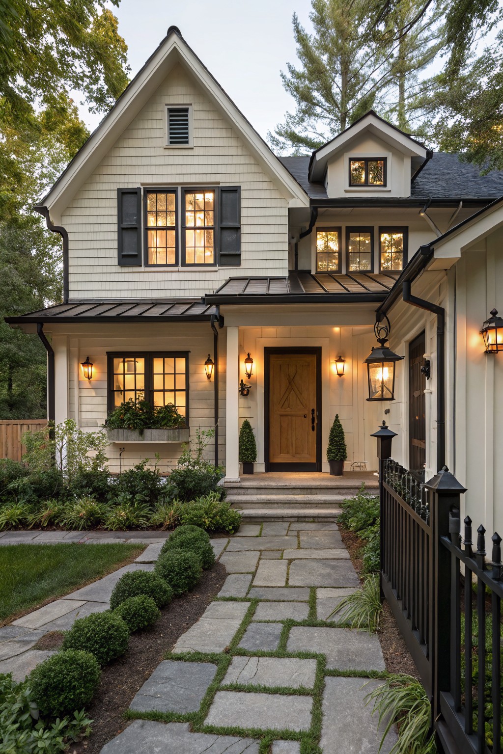 A modern farmhouse exterior with creamy white siding and black window trim.
