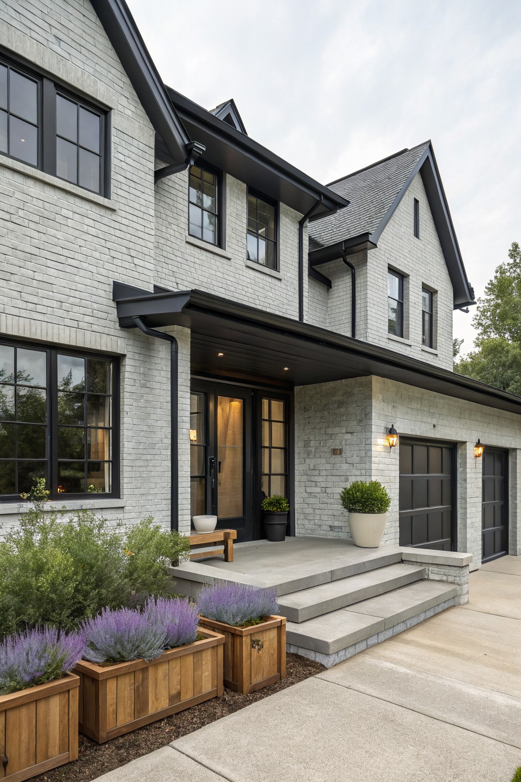 A modern farmhouse exterior with light gray painted brick and black trim.