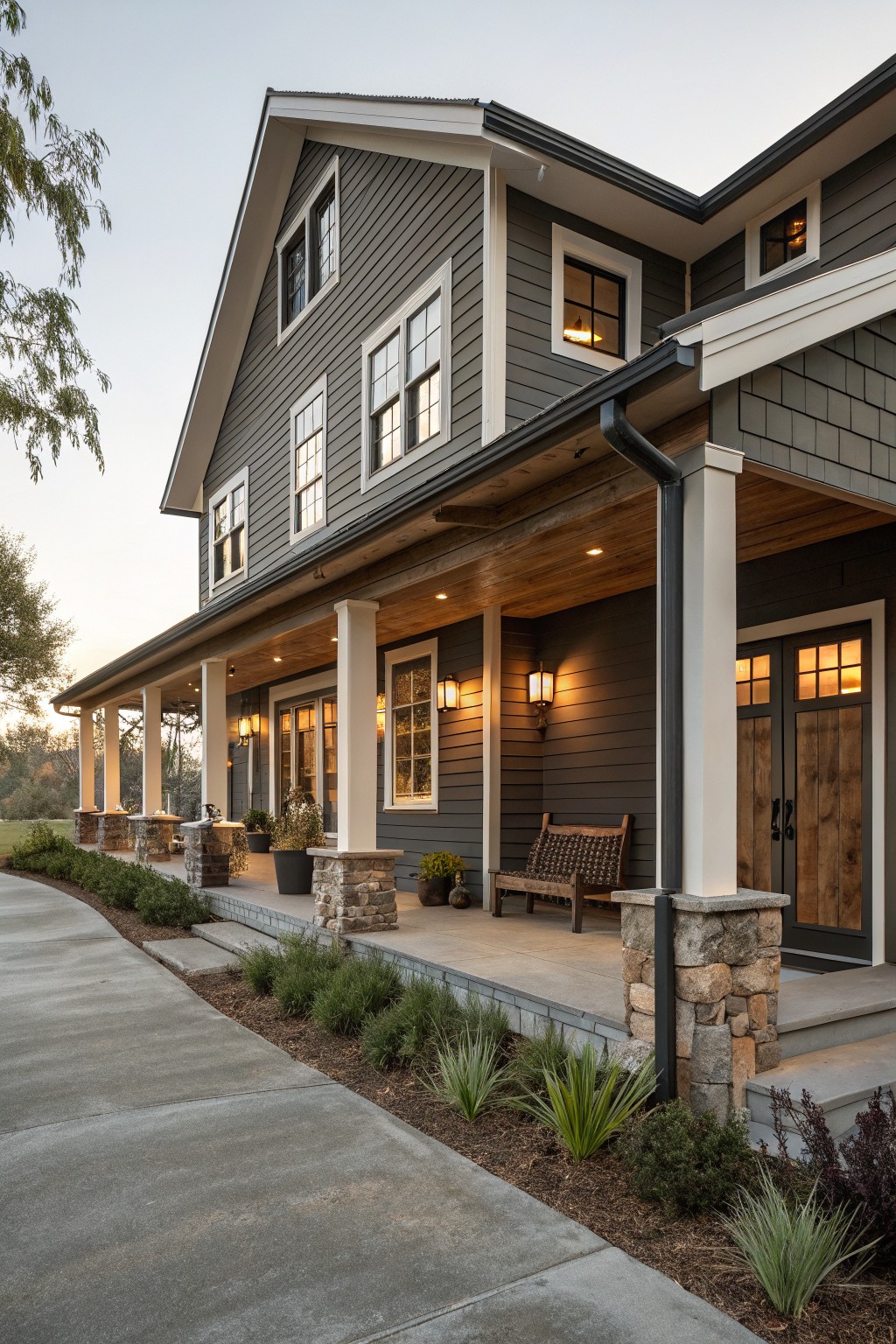 A two-story farmhouse with dark gray siding and white trim.