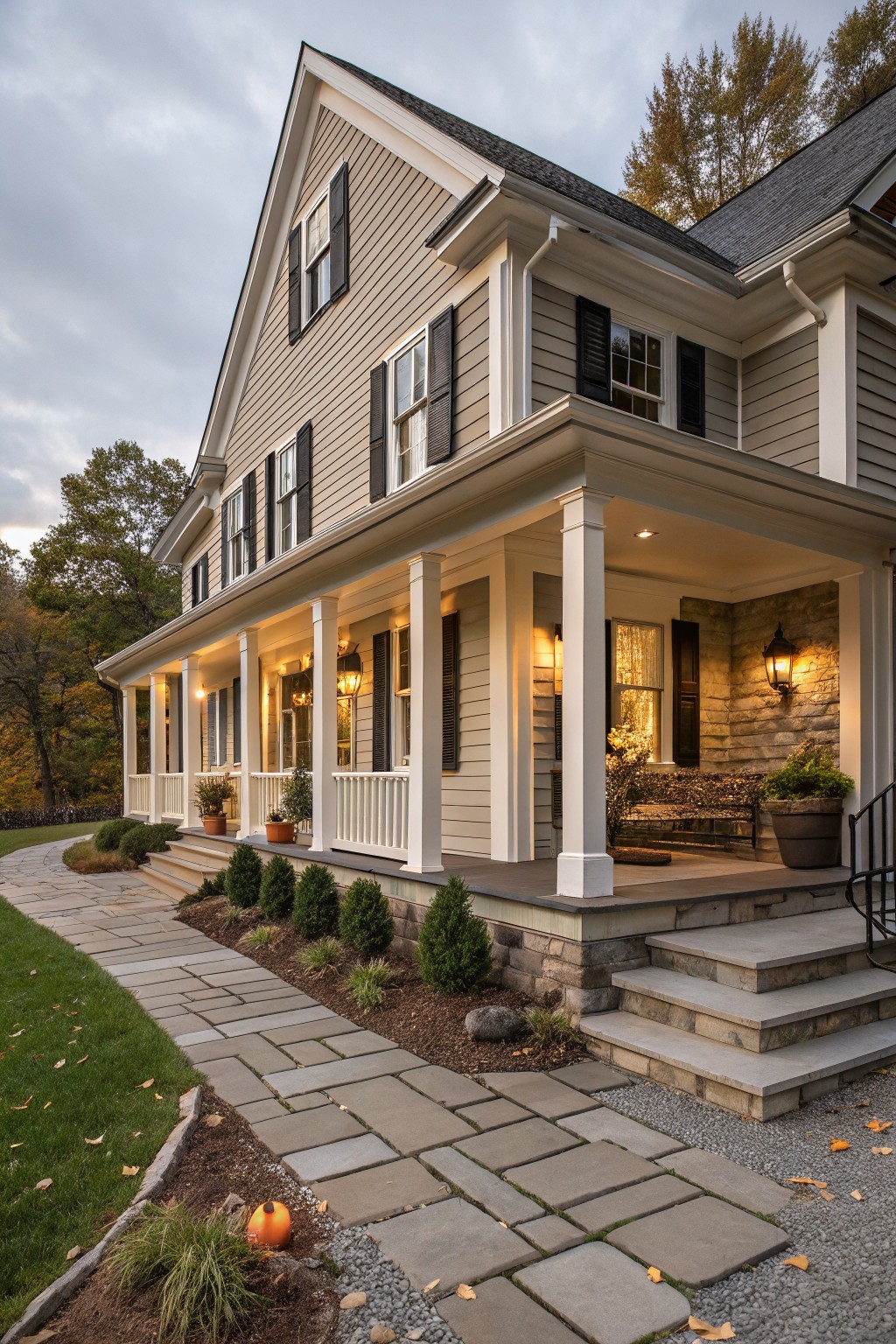 A two-story farmhouse with light greige siding and white trim.