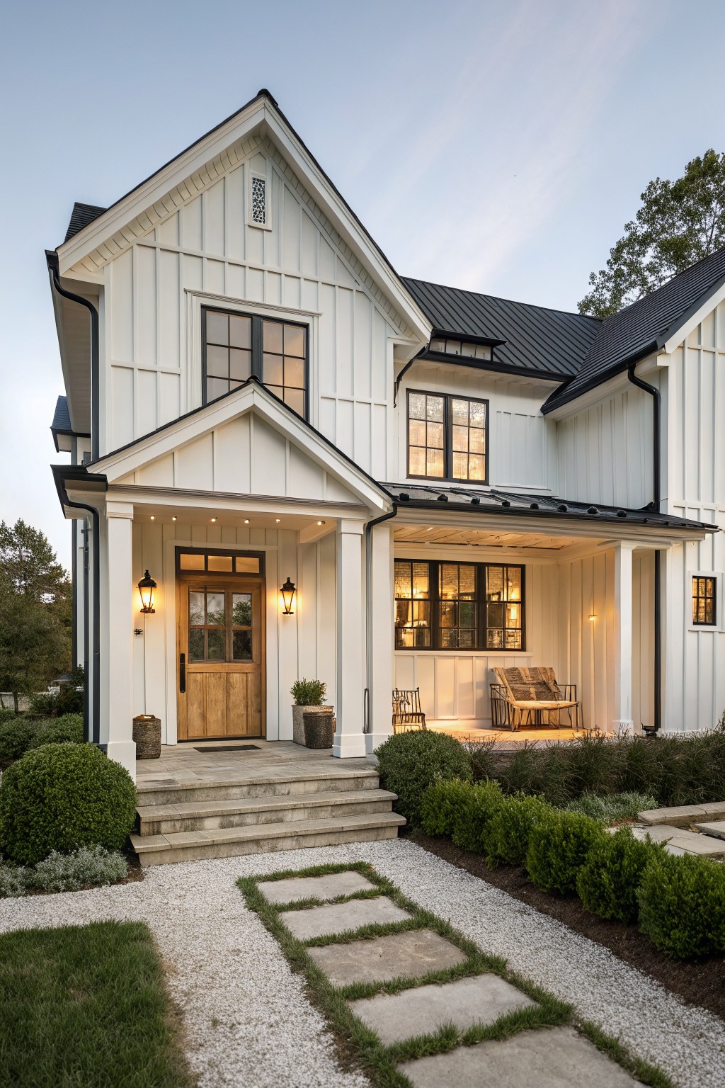 White farmhouse exterior with crisp siding and black trim details.