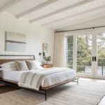 White walls and ceiling in a modern bedroom with wood furniture.