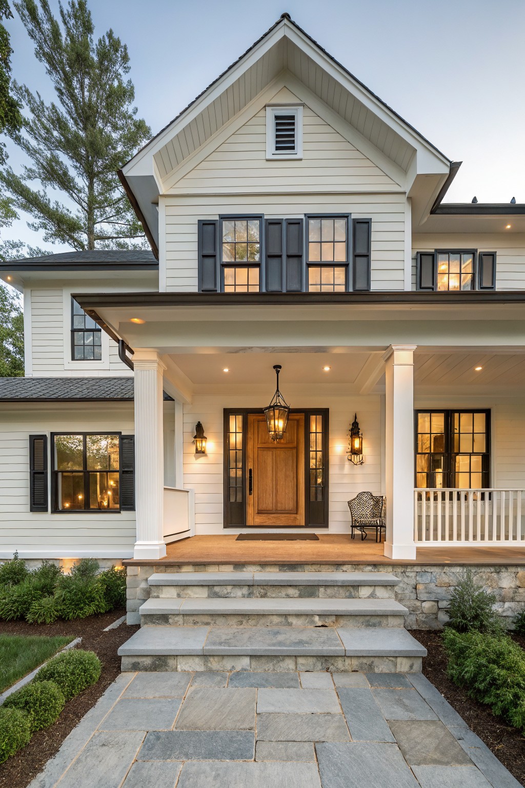A modern farmhouse exterior painted in clean white siding with dark trim and wood accents.