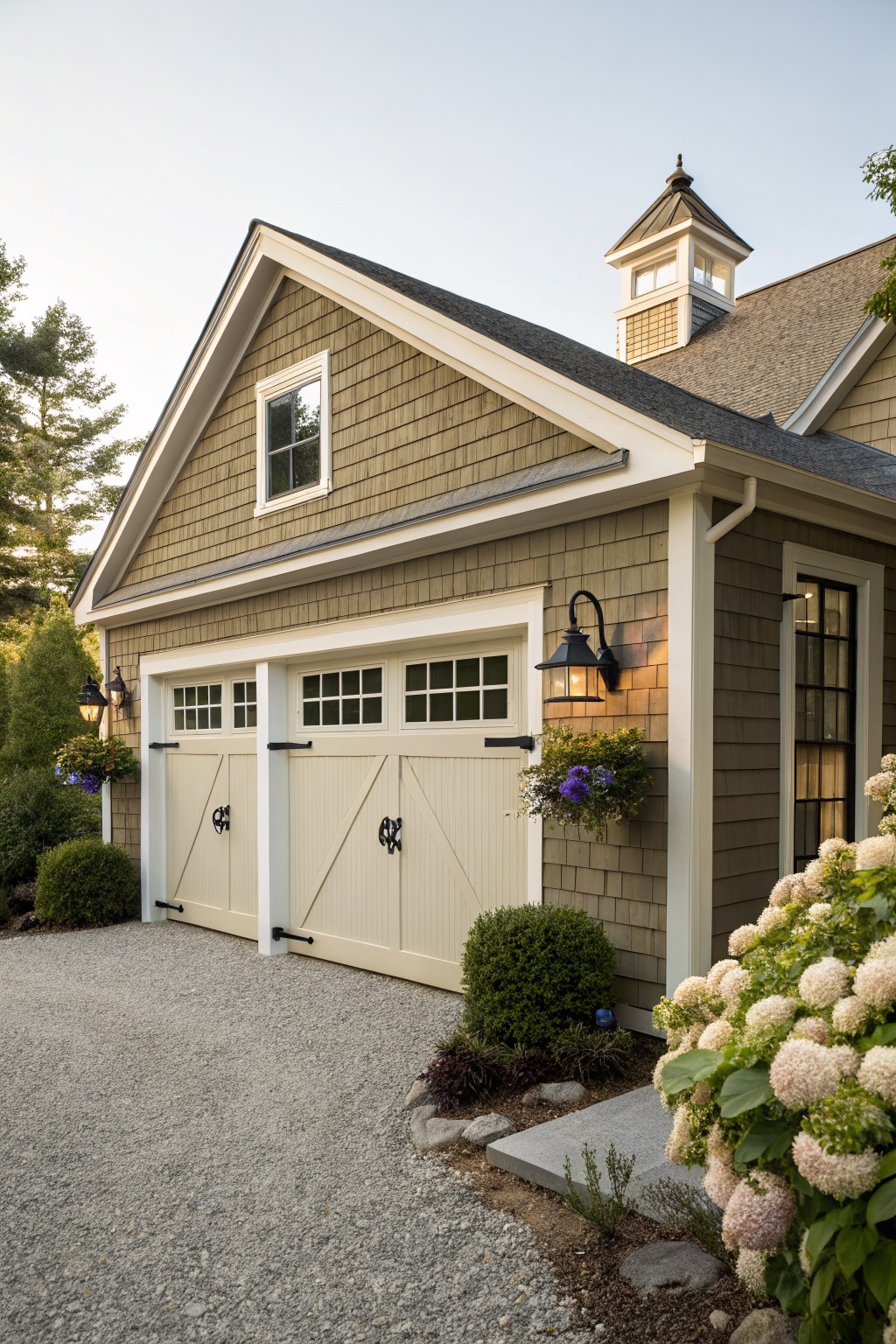 Muted green siding covers the garage exterior with white trim and black hardware.