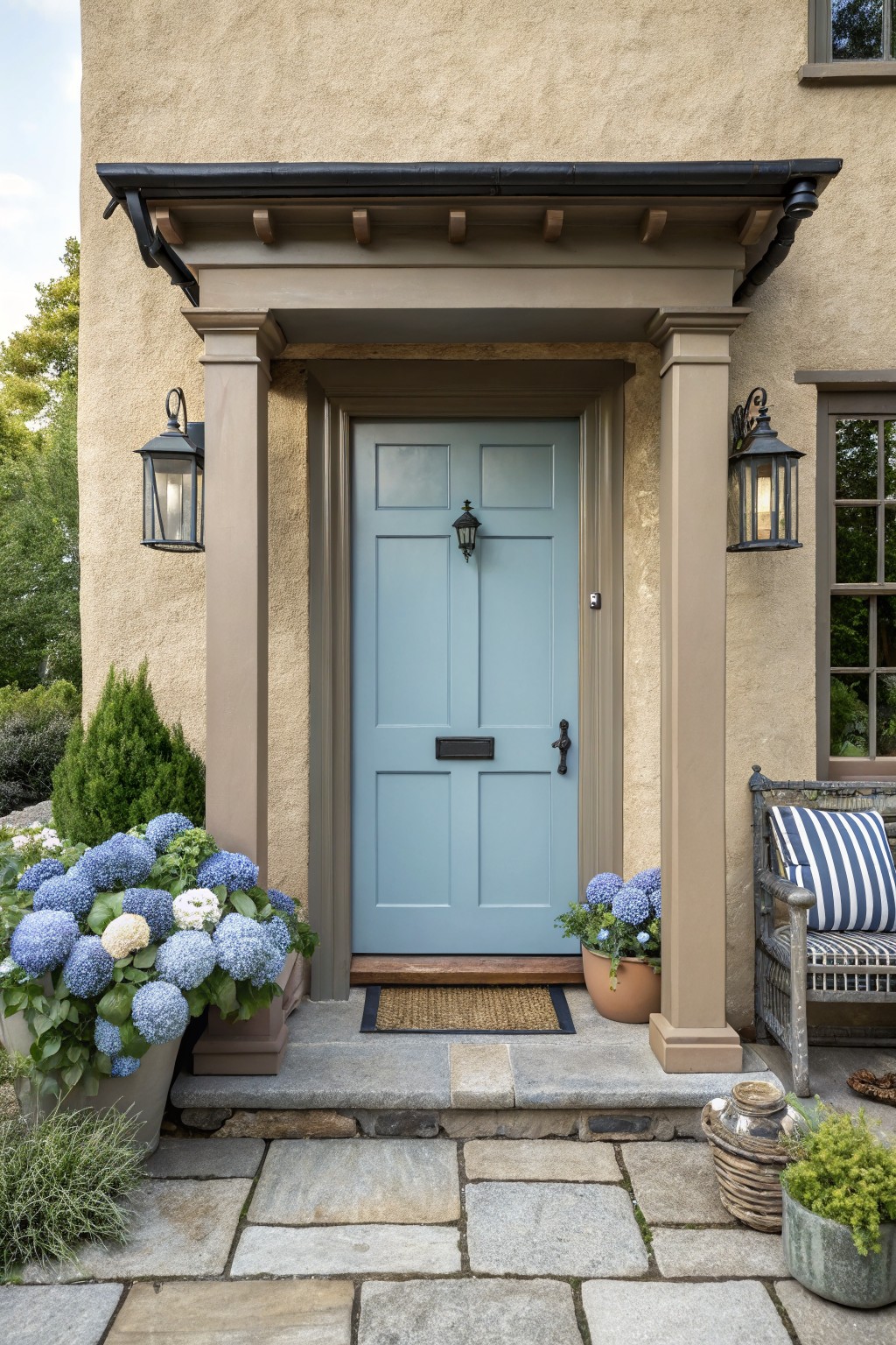 Light blue door entrance with potted hydrangeas, lanterns, and stone steps