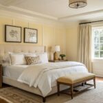 Bedroom with soft warm cream walls and wood furniture.