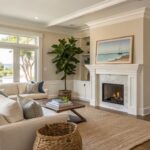 Light warm beige walls in a living room with white trim and wood floors.