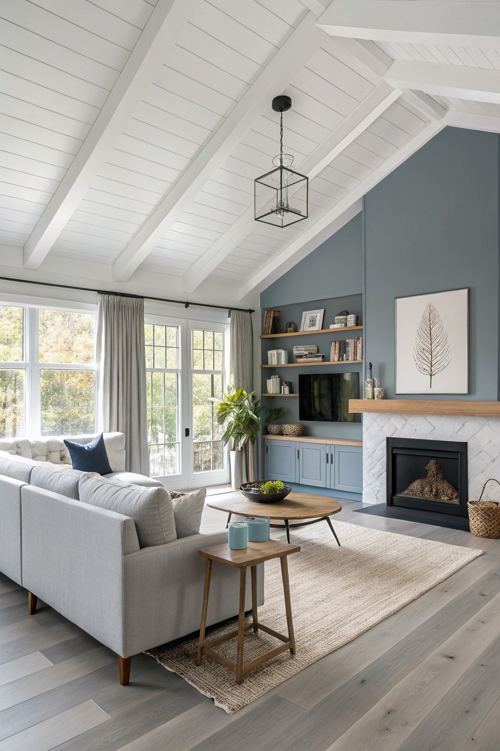 Soft blue gray painted wall behind built-in shelves and fireplace in a living room.