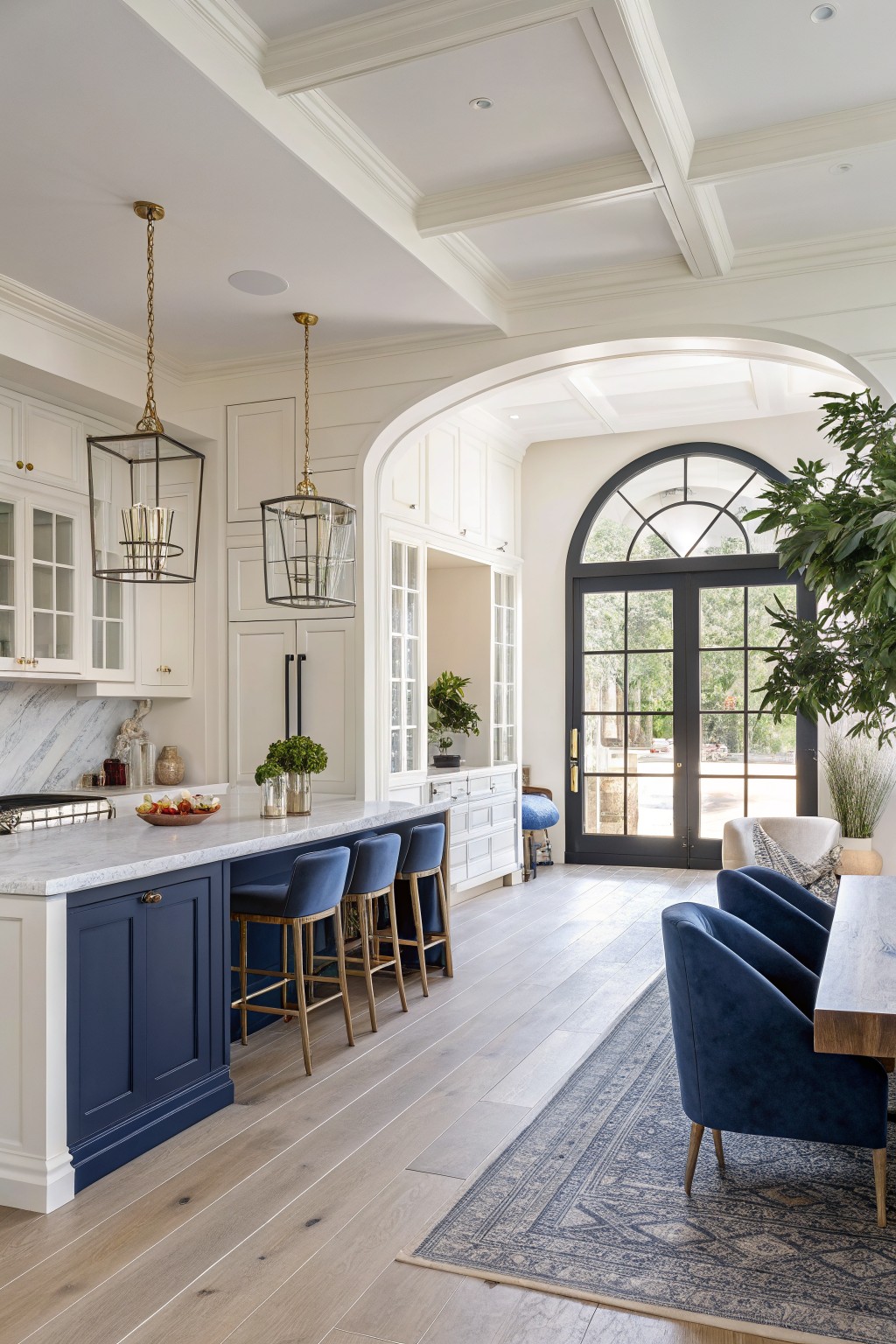 A kitchen with deep navy blue cabinets and a large island in an open living space.