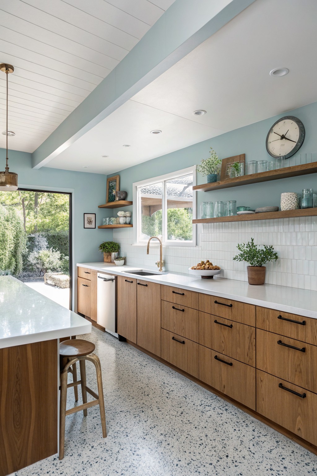 A kitchen with soft blue green walls, white counters, and wood cabinets.