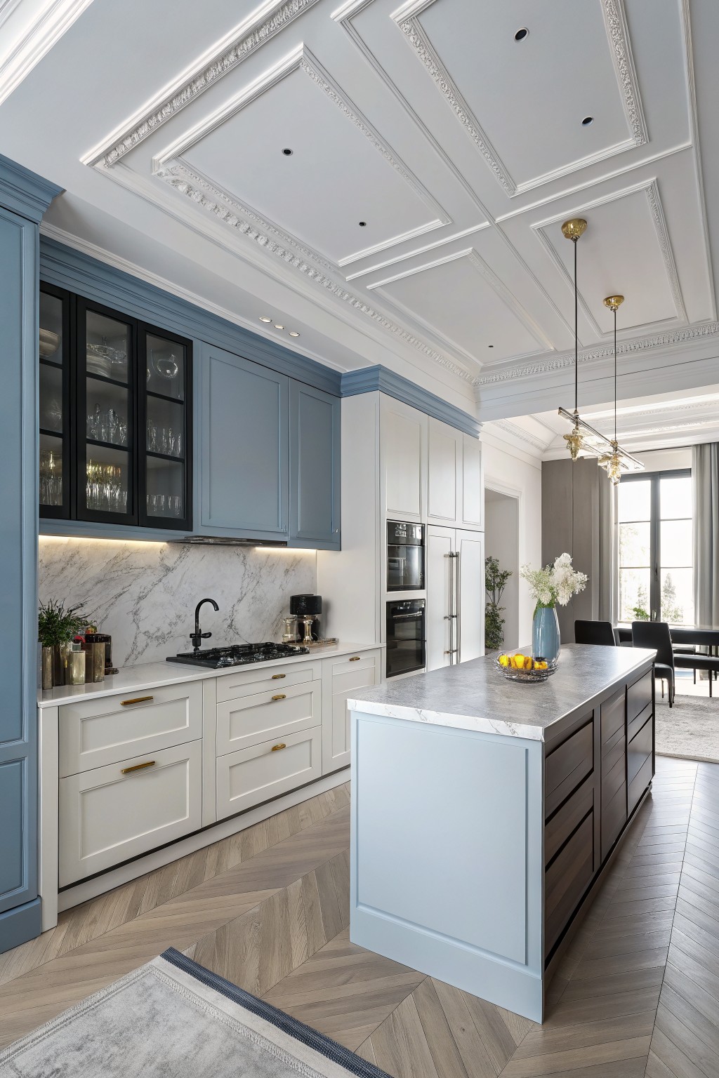 A kitchen with soft blue gray cabinets and a matching island.