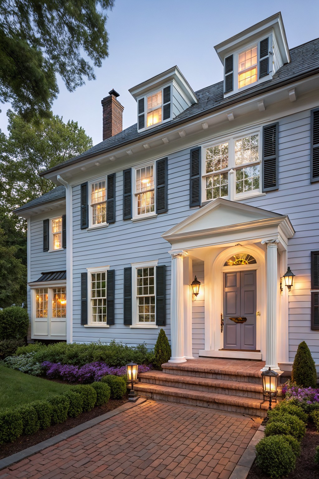 A house exterior painted in soft light blue with white trim.