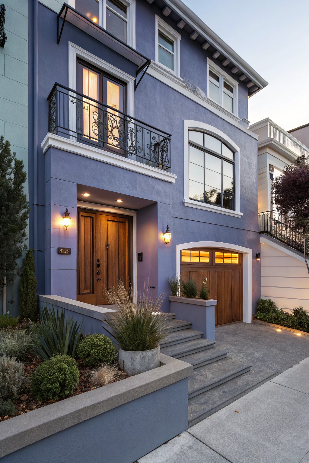 A house exterior painted in a soft blue gray with white trim.